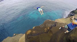 Daredevils cliff jump on Hawaiian paradise island