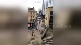 Pedestrians watch firefighters douse Glasgow blaze