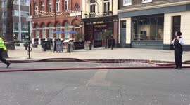 Police with dogs and firemen near New Oxford Street in London
