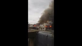 Firefighter sprays building on Sauchiehall street Glasgow after building goes on fire