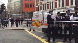Police with dogs at scene of evacuated Cambridge Analytica London office