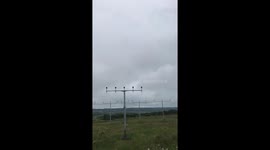 Low flying plane coming in over airport runway