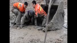 Firefighters rescue woman trapped in mud