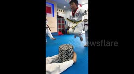 Try as he might, little boy just can’t jump onto stool