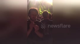 Heavy metal fan calmly paints figurine in the middle of concert