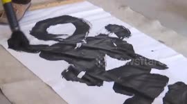 Farmer uses giant writing brush to create calligraphy