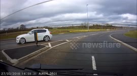 BMW overtakes learner driver on wrong side of UK roundabout