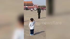 Toddler salutes police on patrol in Tiananmen Square