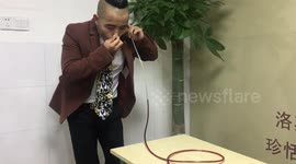 Chinese man is able to drink red wine from glass through his EARS