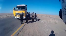 Armed escort attacks and abuses truck-driver.