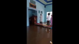 People pray in flooded mosque in Indonesia