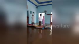 People pray in flooded mosque in Indonesia