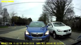 Car mounts pavement and speeds down footpath to undertake vehicles stuck in traffic