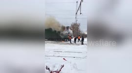Only in Russia: Railway staff douse train blaze with snow