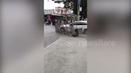 Runaway car smashes down gate during police chase