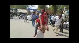 Indian woman carries disabled husband to get him a wheelchair