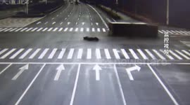 Scooter driver narrowly escapes being buried by lorry after running red light