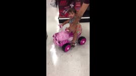 Baby driving a toy car