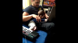 Baby playing with laptop and keyboards