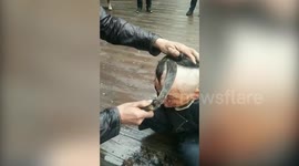 Chinese barber uses sickle to cut hair in China