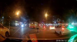Drunken man is sleeping on the busy road where many cars ran
