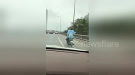 Newsflare Edit - The man carrying his son on the motorbike while the baby is sleeping