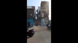 Terrifying moment recently abandoned 3-story building collapses