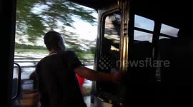 This is how they ride the bus in West Timor! Hanging off the edge!