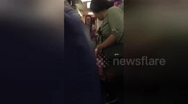 Newsflare Edit - SWA Flight Attendant greeting passengers with baby in hand