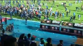 Football fans invade pitch after referee 'makes controversial decision'