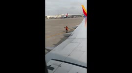 Joyful US airport worker dances while backing up plane