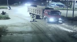 Scooter driver cheats death after rolling under lorry