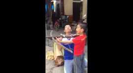 The boy uses a crossbow to pull his teeth