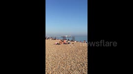 Sun seekers in Brighton head to the beach on UK’s hottest April day in nearly 70 years