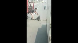 Driver brings rescued snake into truck cab on Indonesian motorway