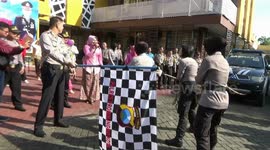 Indonesian women police follow the race of cars, raft guns and make rujak erok erok