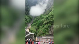 Stunning fog passes through China's famed Tianmen Cave