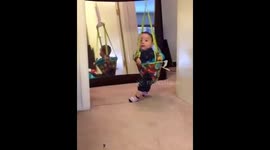Baby gets excited for reflection