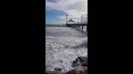 Storm and crashing waves reach Brighton jetty