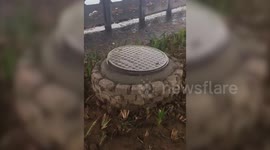 Bizarre moment manhole cover 'dances' in the rain