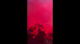 Liverpool fans march down the street with flares before the game against AS Roma