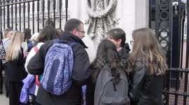People wait in line outside Buckingham palace to view the notice board posted by the royal family announcing the birth of the new royal prince