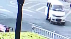 Baby falls out of minibus after it turns a corner