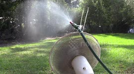 Man hacks oscillating fan to help water grass evenly