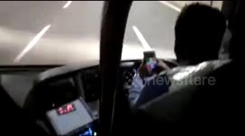 Bus driver plays game on his phone whilst driving on highway