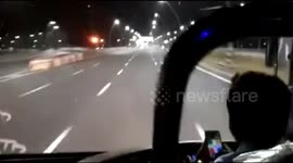 Bus driver plays game on the phone whilst driving on highway