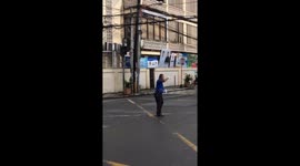Policeman dances while directing traffic at busy junction