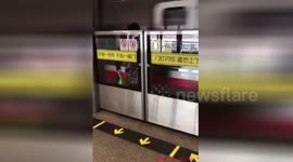 Woman trapped behind subway safety doors as train speeds by