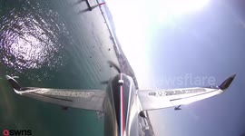 Daredevil pilot flies upside down over French marina