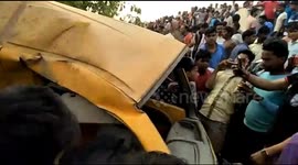 Train hits school van at unguarded crossing in northern India